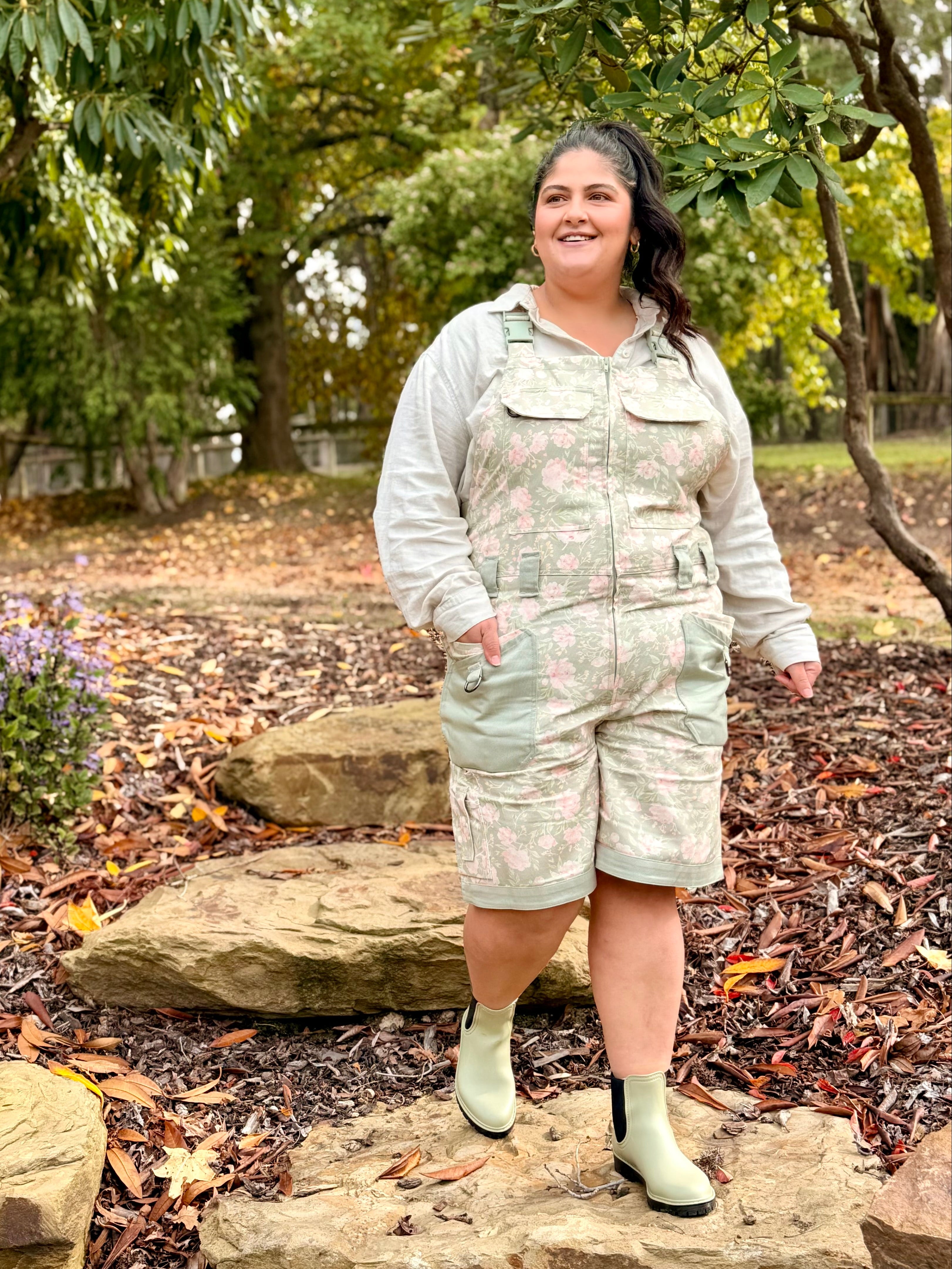 Woman in Peony Meadow Shortalls standing on garden rock steps